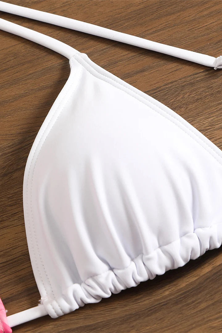 White bikini top on a wooden surface