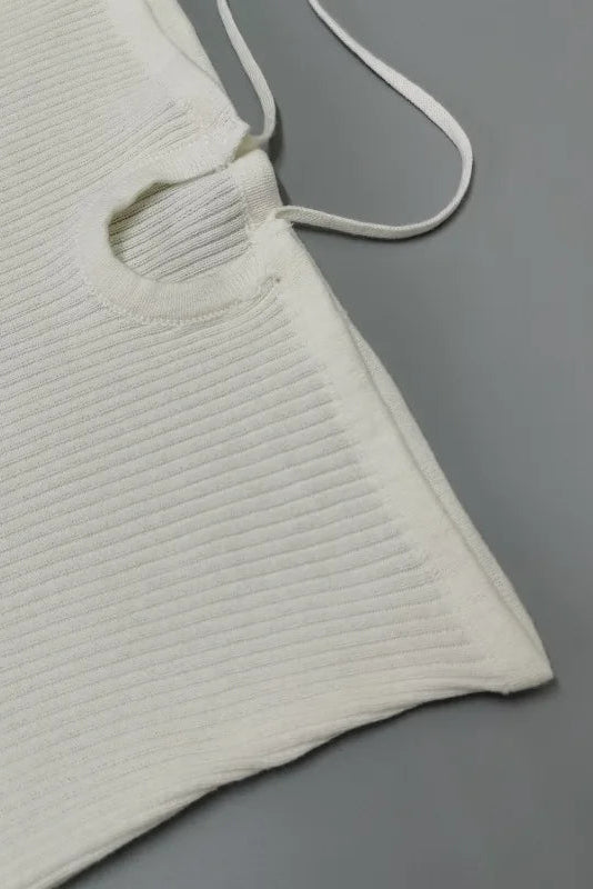 White textured fabric with a strap on a gray background