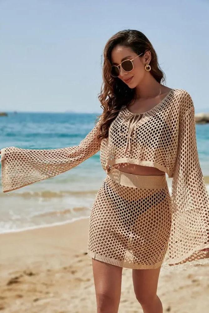 Woman in a beige mesh cover-up on a beach
