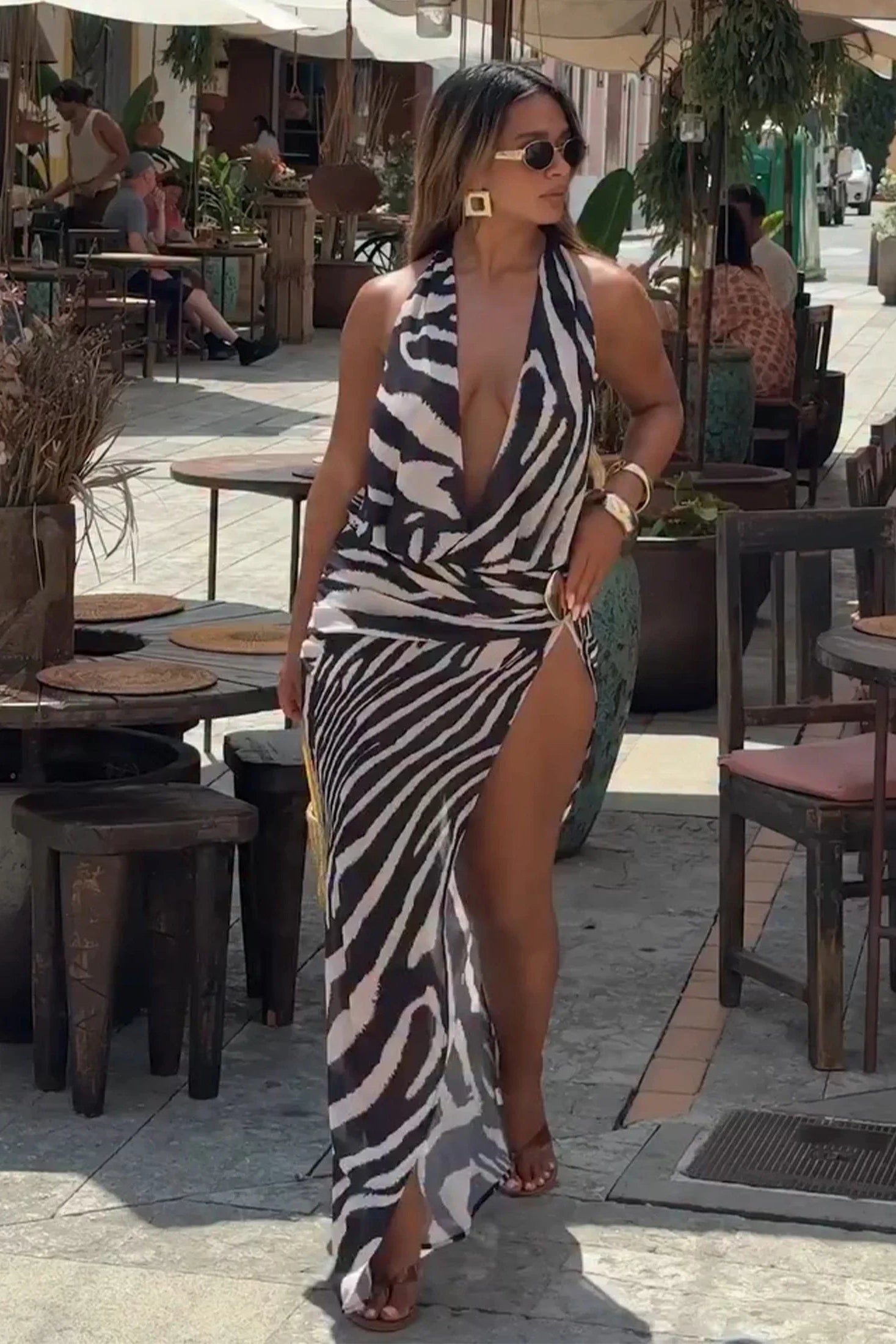 Woman in a zebra print beach wear standing outdoors in a casual setting