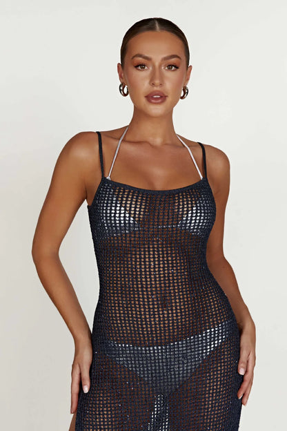 Woman wearing a black mesh dress on a white background