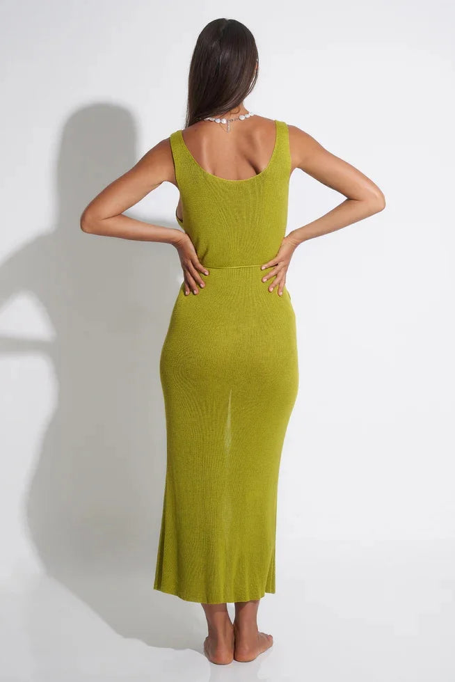 Woman wearing a green cover up against a white background