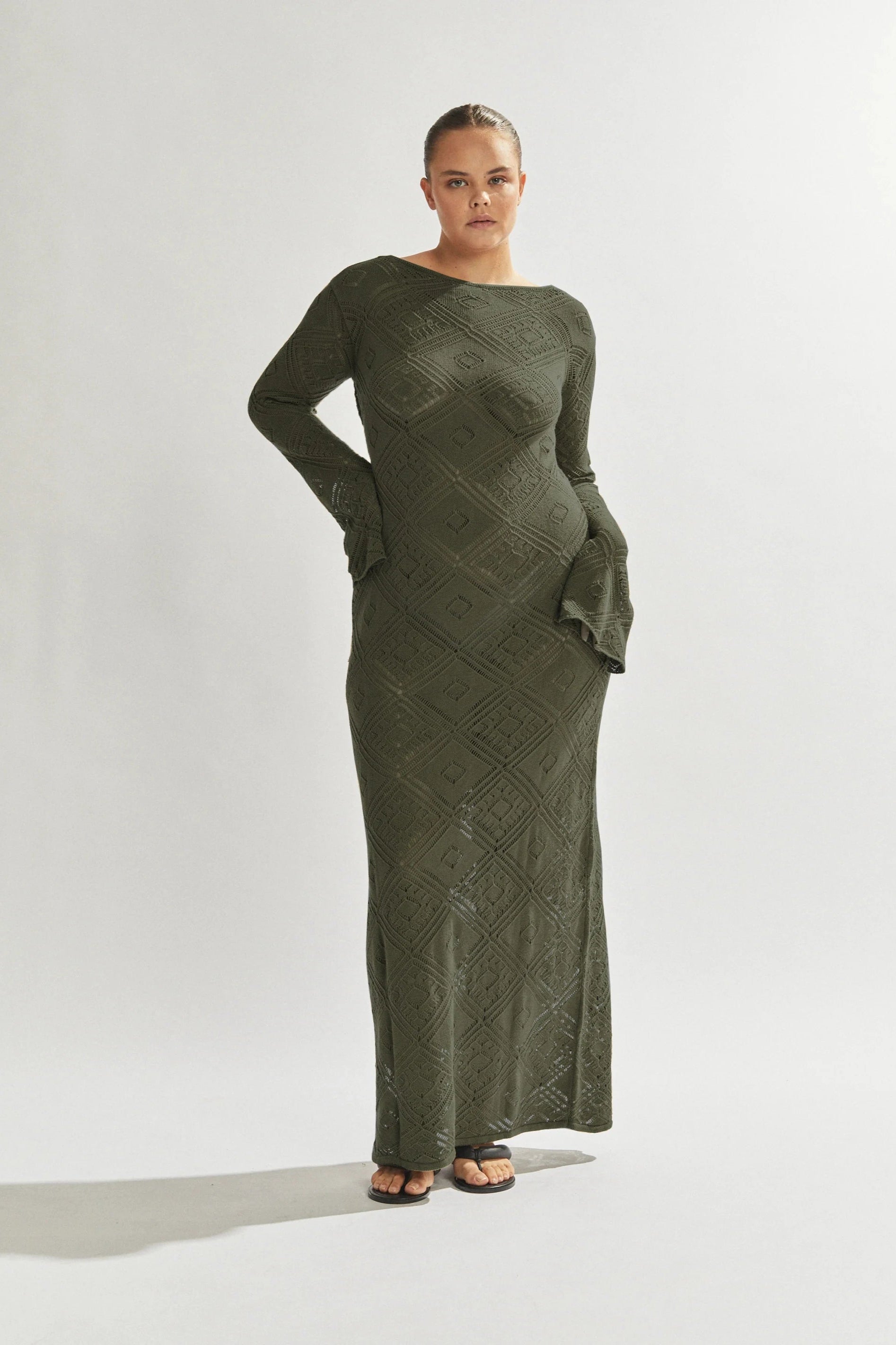 Woman wearing a green dress against a white background