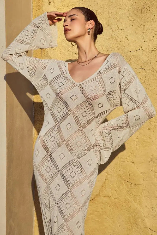 Woman wearing a patterned cover up against a textured yellow wall