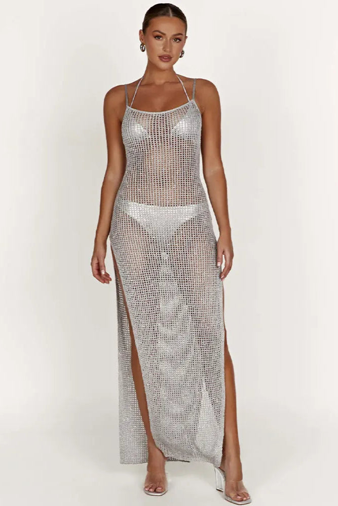 Woman wearing a silver chainmail cover up maxi dress with a white background