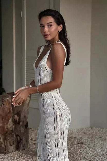 Woman wearing a white lace dress standing outdoors.
