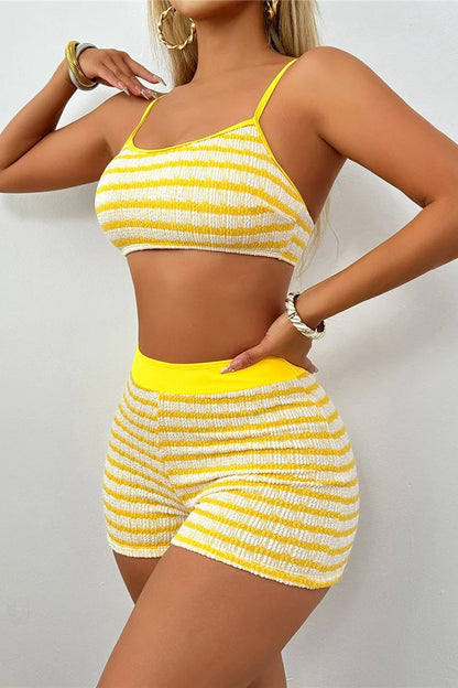 Woman wearing a yellow and white striped two-piece set against a plain background dcostaa swimwears for women