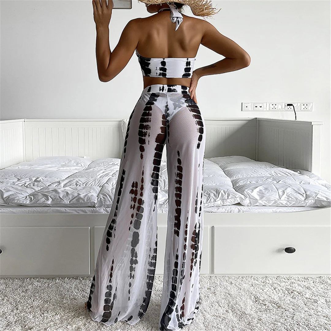 Women wearing a black and white patterned outfit in a bedroom setting