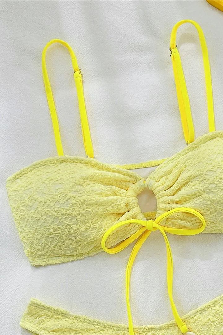 Yellow bikini top on a white background